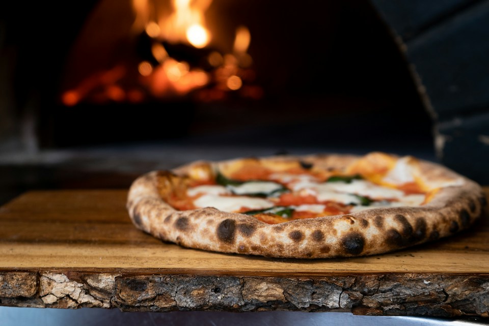 A freshly baked pizza with tomato and melted cheese