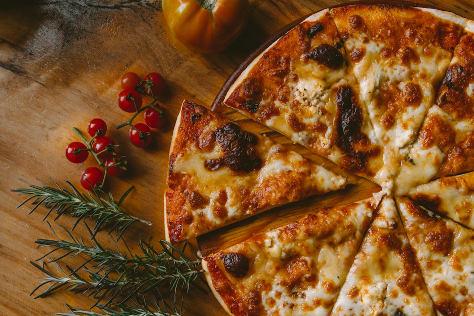 Oven-baked pizza with fresh basil and golden crust